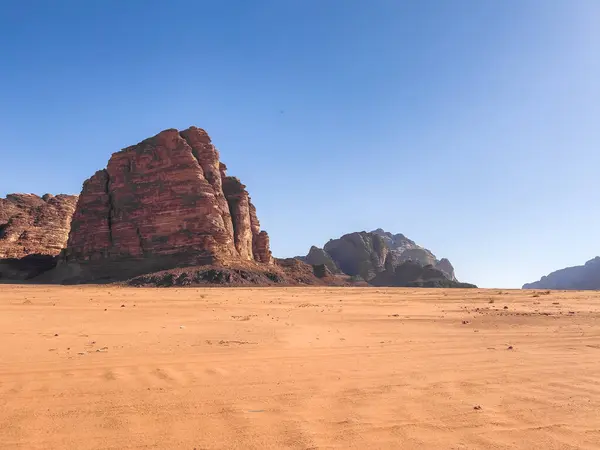 Dry Arid desert landscape under the clear blue sky in a hot summer day. Desert landscape