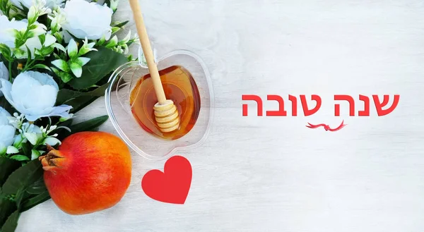 翻译题目 新年快乐 在希伯来石榴 蜂蜜和白花与爱在白色的木制表面 Rosh Hashanah假日 适用于莎娜托娃贺卡 — 图库照片