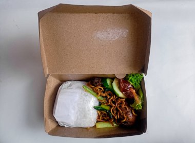 Pirinç, erişte, sebze ve çevre dostu ambalaj kağıdıyla birlikte Endonezya sefertası..