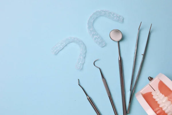 stock image Transparent plastic aligners and dentists tools on a colored background. High quality photo