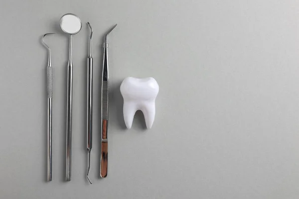Dişçi konsepti. Işık arkaplanındaki diş ve diş aletlerinin maketi ve metin için yeri var. - Evet. Yüksek kalite fotoğraf