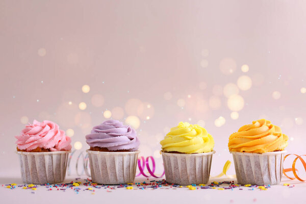 A colorful cupcake topped with creamy frosting and a bright candle, ideal for joyous celebrations