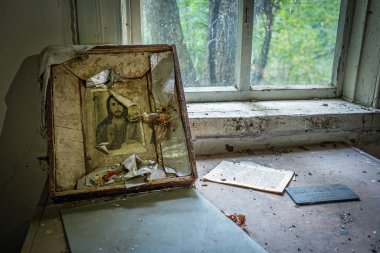 Ukraine, Krasno - 2017, 20 August: old icon in abandoned house in Krasno, small village located in Chernobyl exclusion area in Ukraine.  clipart