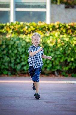 Kareli gömlekli neşeli bir sarışının yaz portresi..