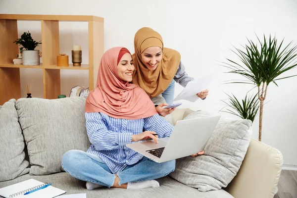 Müslüman genç kadınlar başörtüsü takarak sabah bilgisayardaki müşteri adresini kontrol ve daktilo ile kontrol ederler. Küçük işletmeler ve internetten alışveriş. Bir iş planı hazırlıyorum.