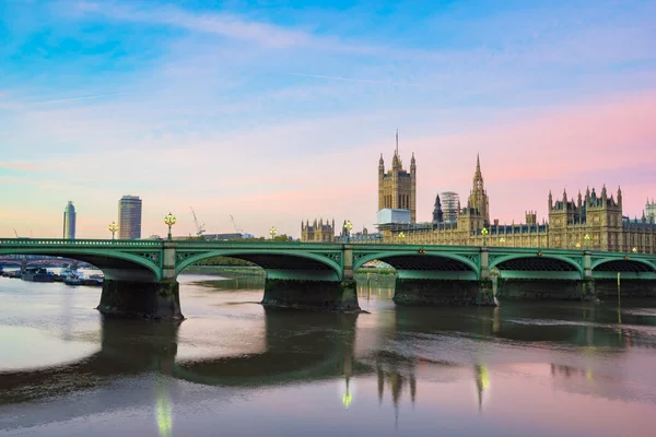 Westminster bridge and British Parliament at sunrise in London. England
