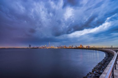 Skyline panorama of Dubai with dark clouds clipart