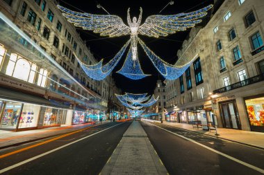 LONDON,ENGLAND - DECEMBER 16,2016: Regent Street with Christmas lights in the shape of a winged angel twinkle in the night clipart