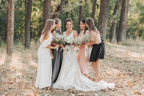 自然の中で結婚式の写真 花嫁と新婦付添人たちは 森の中に立って 花束を持って花嫁を見ています 幸せな結婚式のコンセプト 感情だ 女の子 — ストック写真