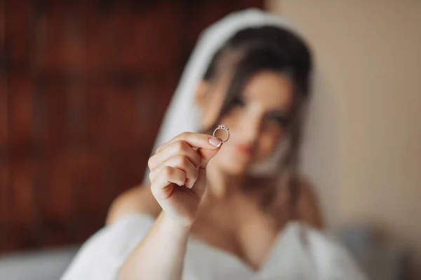 Egy Fehér Ruhás Barna Menyasszony Tartja Ezüst Jegygyűrűjét Homályos Fotó — Stock Fotó