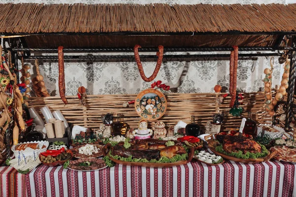 stock image Snacks at the wedding, cheese, sausage, vegetables, meat products, Cossack table at the Ukrainian wedding.