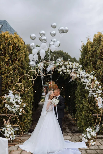 Молодая Супружеская Пара Свадебной Церемонии Поцелуй Жениха Невесты Фоне Летящих — стоковое фото