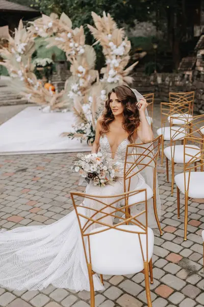 꽃다발과 신부는 결혼식 가장자리와 의자에 — 스톡 사진