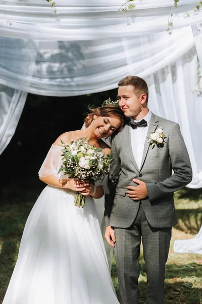 Beautiful wedding couple at a summer wedding ceremony. Wedding vows, emotions and tears