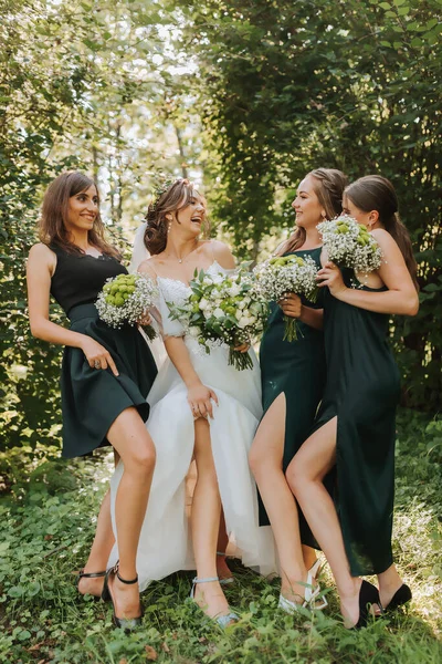 A bride celebrates her wedding with friends outdoors after the ceremony