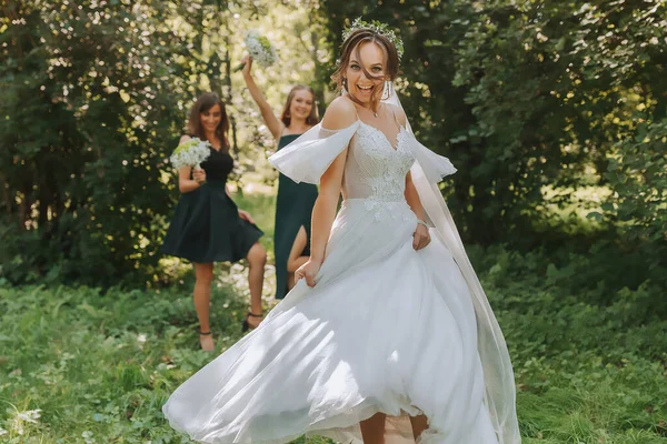 A bride celebrates her wedding with friends outdoors after the ceremony