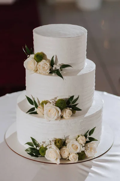 decorated wedding cake, in three tiers, decorated with flowers