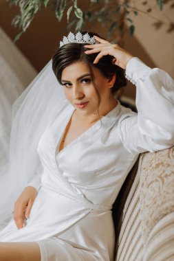 Gelinin sabahının romantik atmosferi. Bakımevinde gelin. Gelin sabahı hazırlığı. Mankenin yanında güzel elbiseli bir gelin ve evde elbisesi var. Her anın tadını çıkar