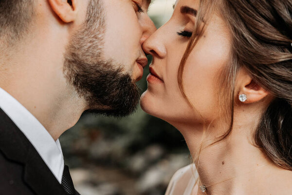 Close-up of the lips of a man and a woman who want to kiss. A stylish man and an elegant girl, a second before a kiss