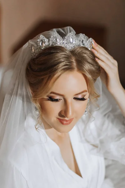 Luxury wedding crown diadem on bride\'s head hairstyle. morning wedding preparation bride with crown close up