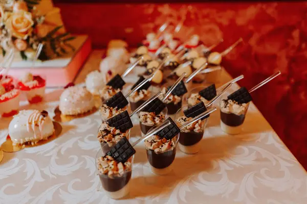 A sweet table at a wedding. Table with cakes and sweets at the festival. Birthday sweets