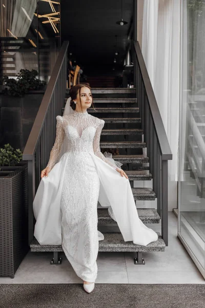 레스토랑의 계단에 세련된 드레스에 앞으로 그녀의 드레스를 보여줍니다 결혼식 날이에요 — 스톡 사진