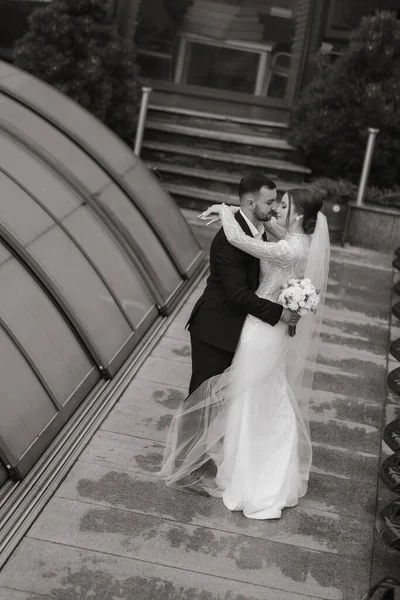 tender hugs of the bride and groom. The groom embraces the bride. Photo from above. Black and white photo