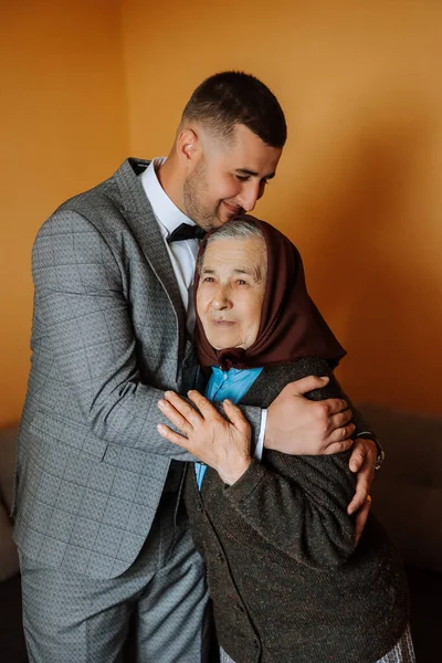 photo with grandmother at the wedding. A happy grandmother is happy for her uncle, who will soon get married. Touching moments at the wedding