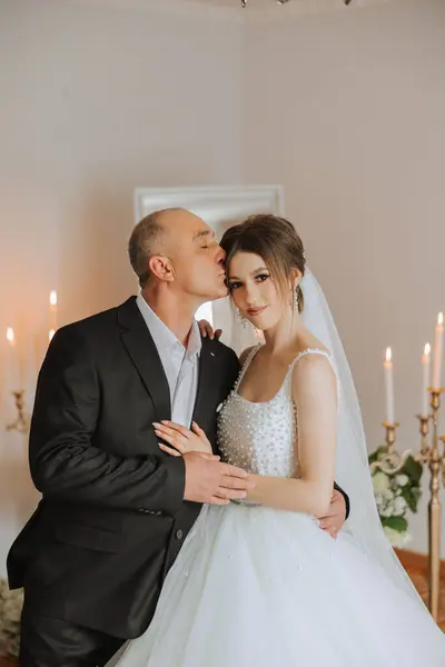 A beautiful bride with her father on her wedding day. The best moments of the wedding day. Daughter and father.