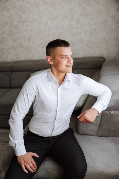 Stylish portrait of the groom preparing for the wedding ceremony in the morning. Groom\'s morning. Preparation for the groom\'s morning. Husband\'s experiences before the wedding.