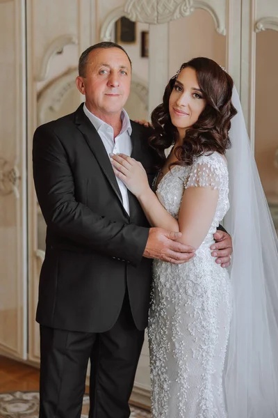 A beautiful bride with her father on her wedding day. The best moments of the wedding day. Daughter and father.