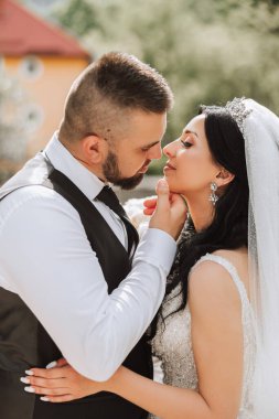 Doğada bir çiftin birbirine bakarken çekilmiş yakın plan fotoğrafı. Gelin ve damat doğanın ortasında birbirlerine bakıyorlar. Gözlerinde şefkat ve sevgi.