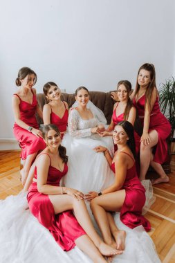 Güzel bir gelin ve nedimeleri sabah eğleniyorlar. Düğün kutlaması. En iyi arkadaşlarının düğününde mutlu kızlar. Nedimeleriyle güzel ve zarif bir gelin.