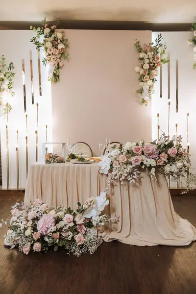 Restaurant wedding table for bride and groom. luxury wedding table with beautiful flowers. pink stylized