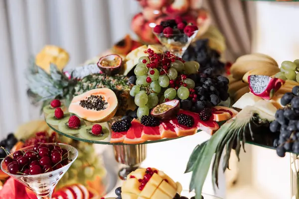 Fruit buffet for a wedding. Assortment of exotic fruits in the restaurant. Various compositions from fresh fruits.
