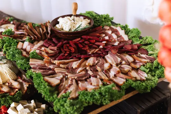 Meat and cheese snacks on the buffet. A buffet in a closed room, at a wedding celebration or birthday. Sandwiches on skewers before the start of the holiday.