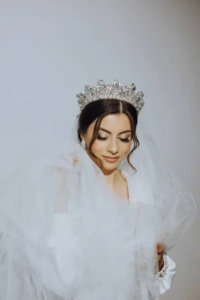 Luxury wedding crown diadem on bride\'s head hairstyle.Portrait. Morning wedding preparation bride with crown close up