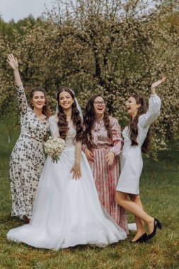 Siyah takım elbiseli damat doğadaki yeşil çimlerin üzerinde yürüyor. Klasik siyah takım elbiseli zarif bir adam.