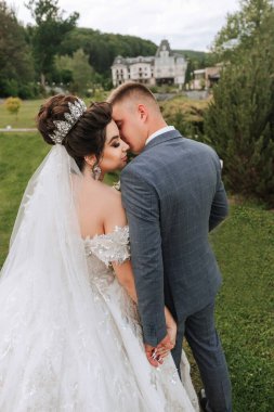 Bir gelin ve damat bir tarlada birbirlerini kucaklıyor. Damat takım elbise giyerken gelin beyaz bir elbise ve taç giyiyor. Sahne romantik ve samimi, aşkı yakalıyor.