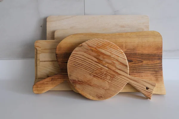 Wooden chopping boards on kitchen countertops. Set of wood cutting boards in different sizes.