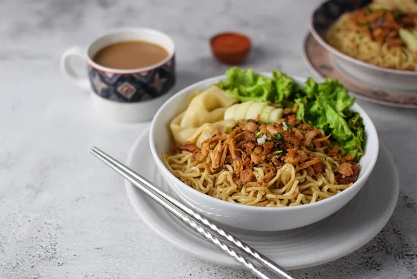 stock image Mie ayam, noodles with chicken and vegetables, Indonesian traditional food in grey texture background.