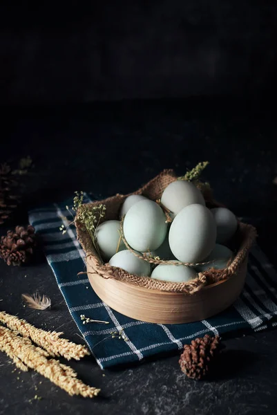 fresh raw duck eggs on bamboo basket and sackcloth with dark and texture background. one egg are broken. Duck Egg Yolk salted