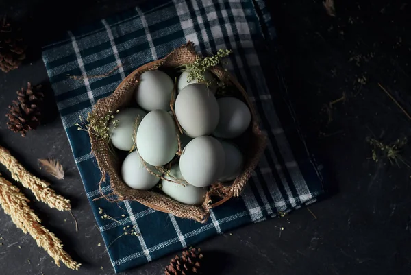 fresh raw duck eggs on bamboo basket and sackcloth with dark and texture background. one egg are broken. Duck Egg Yolk salted
