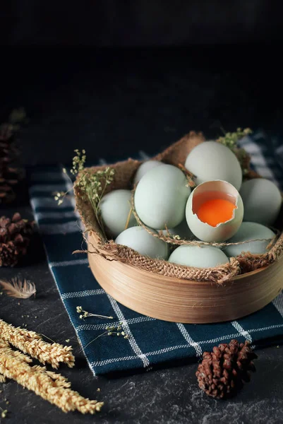 fresh raw duck eggs on bamboo basket and sackcloth with dark and texture background. one egg are broken. Duck Egg Yolk salted