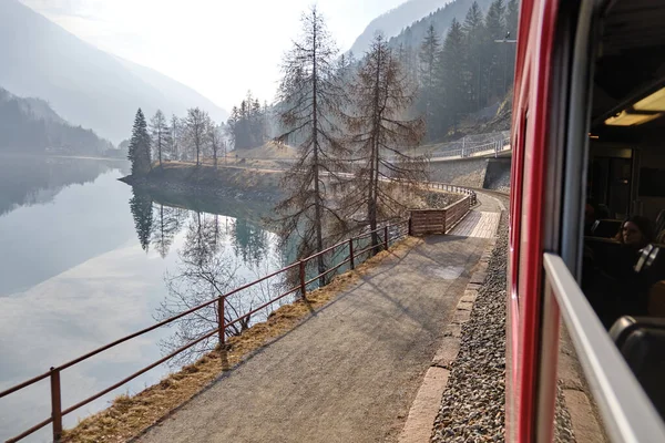 stock image Panoramic view of the forest lake. Clear blue sky with dramatic glowing clouds after the rain. The Poschiavo lake in Switzerland. Sunny sky.