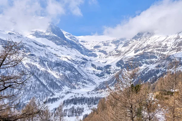 Canton Graubunden, Switzerland : Landscape in Alp Grum train station (Bernina express) during winter season, swiss alps in backgroud