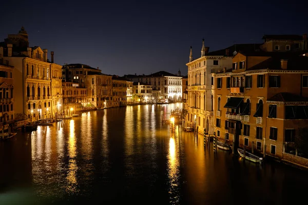 stock image Venice, Italy: Night view of Venice Grand Canal with boats and Santa Maria della Salute church on sunset from Ponte dell'Accademia bridge.