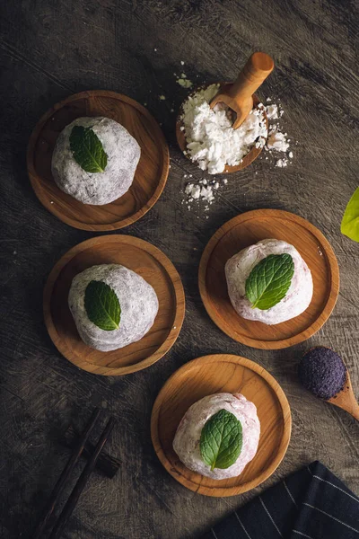 Japanese mochi or rice cake filled with red bean and strawberry, mint leaves on top. Japan traditional rice cake.