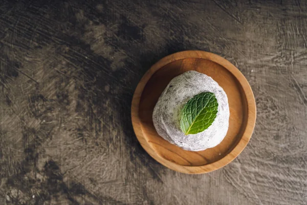 stock image Japanese mochi or rice cake filled with red bean and strawberry, mint leaves on top. Japan traditional rice cake.