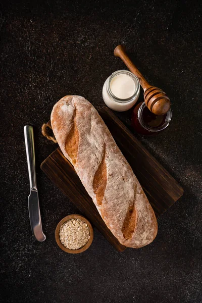 stock image Fresh homemade artisan loaf of baguette breads on rustic background with copy space. sourdough mini baguette breads.